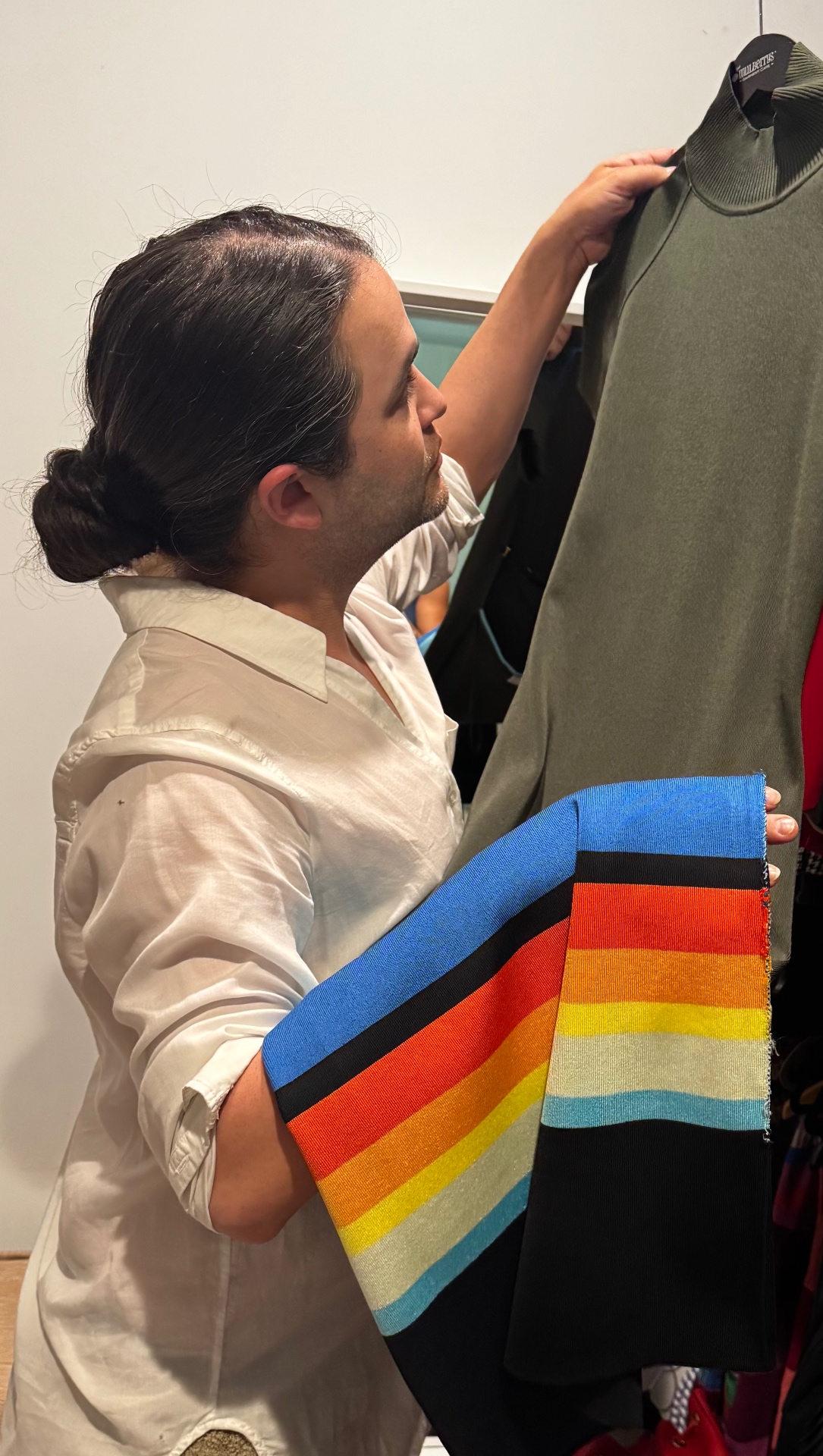 Carwin Brice comparing fabrics during a closet edit